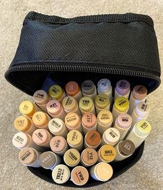 a bag filled with lots of different colored markers