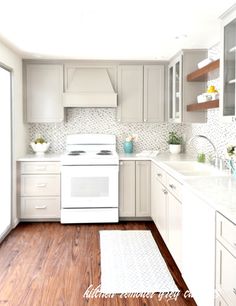 a white stove top oven sitting inside of a kitchen