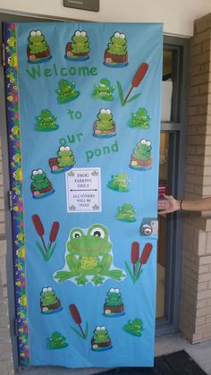 a blue door decorated with frog images and words