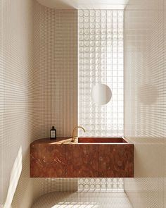 a bathroom with a sink and mirror next to a wall made out of white circles