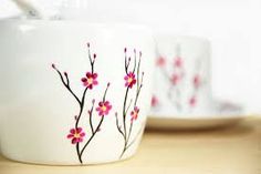 two white cups with pink flowers painted on them