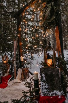 candles are lit in the snow near some trees