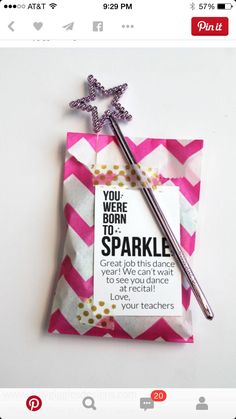 a pink and white chevron paper bag with a pen in it, which says you were born to sparkle