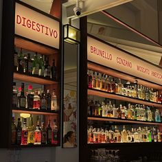 the shelves are filled with different types of liquor