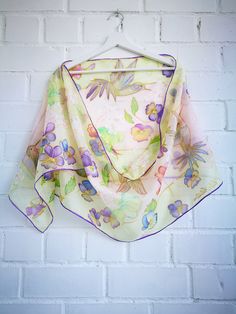 Hand painted Elegant Floral pale Pink-Green Silk scarf in Pansies theme. Lots of freely falling colorful pansies, some pale pink/white geraniums melting in the background and humming birds flapping around the flowers. Pansies symbolize Friendship, Loyalty, Love, Remembrance. Geranium means Happiness and positive emotions. Humming birds are Lightness of being, Independence and bring Playfulness and Joy in your life. Scarf is painted on Ponge Silk. It is light, soft, just a little glossy and very Floral Print Silk Shawl Scarf For Gift, Floral Print Silk Shawl Scarf As Gift, Multicolor Floral Scarves As Gifts, Multicolor Summer Shawl As Gift, Multicolor Floral Print Scarves For Gifts, Summer Multicolor Shawl As Gift, Multicolor Floral Print Scarves As Gift, Multicolor Shawl As Summer Gift, Handmade Multicolor Spring Scarves