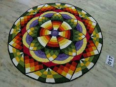 a colorful circular rug is on the floor next to a price tag for $ 10