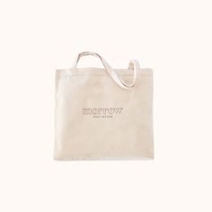 a tote bag with the words tomorrow printed on it, sitting against a white background