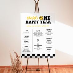 a sign on a easel in front of a white wall that says, brain's one happy year