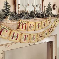 a merry christmas banner hanging from the mantle