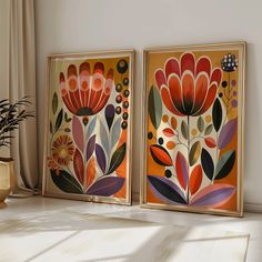 there are two paintings on the wall next to a vase with flowers in it and one is orange