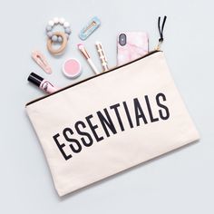 The perfect pouch for all of your essentials, obviously.Our extra large canvas pouches are ideal for holidays, adventures and everyday life! These versatile zip pouches are great for travel documents and passports, makeup and beauty essentials, and are also perfect for storing a few nappies, wipes and baby bits. Ideal for parents looking to carry their supplies in style!The 'Essentials' design has been screen printed in black ink onto thick canvas with a black cotton lining. The pouches have been lovingly made in the UK, complete with a heavy-duty gold colour zip and black suede zip pull.The perfect companion to our Everything REALLY big bag! Made in the UK Heavy natural canvas Screen printed in black Black cotton lining Sturdy zip and suede zip pull 350mm by 250mm (14 by 10 inches) Canvas Bag Design, Essential Pouch, Travel Documents, Teachers Day Gifts, Extra Large Canvas, Large Pouch, Travel Wallet, Essential Bag, Big Bags