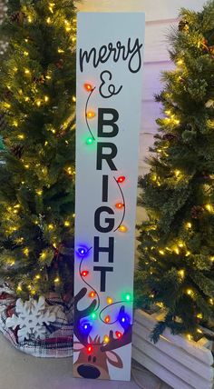 a sign that says merry and bright with lights on it in front of christmas trees