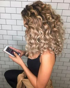 brick wall in white, behind a blonde woman, with shoulder length ombre curls, dressed in a black tank top, with black leggings, and a beige jumper tied round her waist Ombre Curly Hair, Best Ombre Hair, Blonde Curly Hair, Colored Curly Hair, Ombre Hair Color, Permed Hairstyles, Shoulder Length Hair, Brunette Hair Color, Ombre Hair