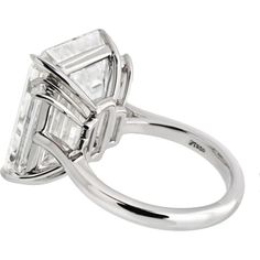 Discover the confluence of artistic legacy and contemporary creativity with this mesmerizing 15-carat Emerald Cut Diamond Engagement Ring. At the heart of this masterpiece is a breathtaking 15.30-carat emerald-cut diamond, certified by GIA, showcasing an I color grade and internally flawless (IF) clarity. This diamond is a true marvel; its large table and elongated facets create a dance of light that reveals an inner fire, often overshadowing the subtle hints of color within. The I color grade, Luxury Gia-certified Platinum Diamond Ring, Luxury Gia Certified Diamond Engagement Ring, Luxury Gia Certified Emerald Cut Diamond Ring, Emerald Cut Diamond Engagement Ring, Emerald Cut Diamond Engagement, Yellow Jewelry, Emerald Cut Diamond, Ring Watch, Large Table