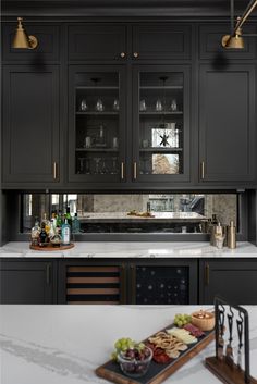 an image of a kitchen with dark gray cabinets and white counter tops, along with the words home bunch above it