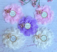 four flower hair clips with the words happy birthday on them and some flowers in front