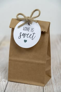 a brown paper bag with a tag that says love is sweet