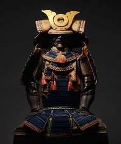 an elaborately decorated samurai statue sitting on top of a table