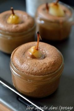 three desserts in glass containers on a table