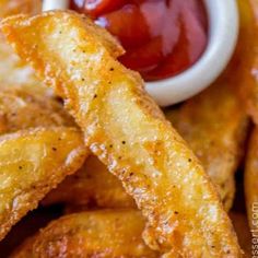 fried onion rings with ketchup on the side