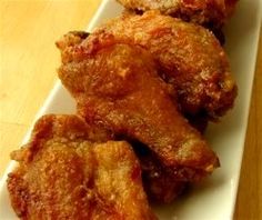 three pieces of fried chicken on a white plate