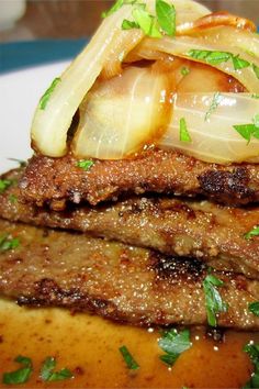 some food that is sitting on top of a white plate with green garnish