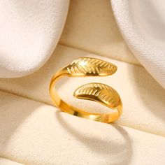 a gold ring sitting on top of a white cloth