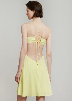 Color: Elfin Yellow Woven jersey with stretch Relaxed silhouette Mini length Halter neck spaghetti straps ties Cut out detail waist to back Tie straps on back 100% Viscose Machine Wash By ROTATE Birger Christensen. Imported Model is 179cm/5'10" wearing a size 36DK/4US Spring Sundress With Lace-up Back And Spaghetti Straps, Strappy Summer Dress With Lace-up Back, Backless Strapped Sundress For Spring, Spring Tie Back Cross Back Dress, Spring Halter Neck Backless Dress With Straps, Summer Dress With Straps And Cross Back, Spring Fitted Strappy Backless Dress, Spring Backless Dress With Crisscross Straps, Fitted Backless Strappy Dress For Spring