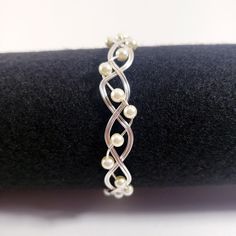 a silver bracelet with pearls on it