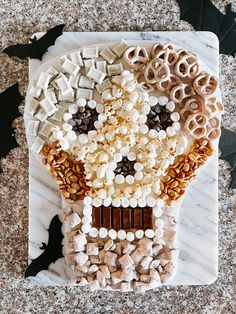 an assortment of halloween treats on a marble platter