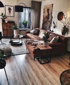 a living room filled with furniture and plants