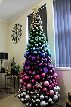 a brightly colored christmas tree in a living room