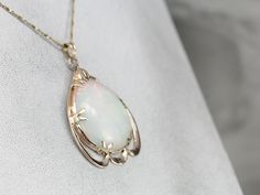 This vintage rose gold pendant is a great frame for the outstanding Opal gemstone that we've set at the center. This is a wonderful stone, filled not only with greens and oranges but also with a rare, pink glow at the center! The perfectly proportioned teardrop shape creates an outstanding profile along the throat. This pendant does not come with the chain shown. Please feel free to contact us, we will help you find the perfect chain for your style and budget! Metal: 10K/18K Rose Gold Gem: Opal Formal Rose Gold Jewelry With Large Pendant, Elegant Opal Jewelry With Cabochon, Elegant Opal Cabochon Jewelry, Rose Gold Collectible Necklaces, Collectible Rose Gold Necklaces, Antique Oval Cabochon Gemstone Necklaces, Fine Jewelry Cabochon Gemstone Pendant, Antique White Gold Gemstone Necklace, Oval Large Pendant Fine Jewelry