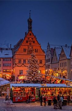 a christmas tree is in front of some buildings