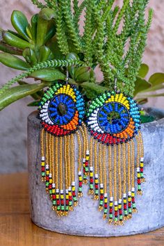 Zulu Beaded Tassel Earrings - Leone Culture Elegant Multicolor Beaded Hoop Earrings, Elegant Multicolor Hoop Earrings With Dangling Beads, Bohemian Beaded Chain Earrings For Party, Large Beads Earrings For Party, Festival Beaded Chain Earrings, Colorful Dangle Beaded Earrings For Party, Unique Beaded Chandelier Earrings For Party, Large Beads Party Earrings, Elegant Large Beads Drop Earrings