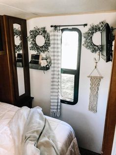 there is a bed in the room with two mirrors on the wall next to it