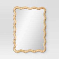 a wooden frame mirror hanging on the wall