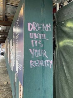 graffiti written on the side of a green box