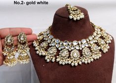 * Light weight gold white, marron necklace set studded with crystals. *Necklace Width- 2 inches *Earrings Length- 2.8 inches(included drops) *Earrings Breadth- 0.9 inches White Round Kundan Necklace With Stone Work, White Kundan Necklace With Stone Work, Heavy White Round Kundan Necklace, Heavy White Kundan Necklace, Gold Kundan Necklace, Indian Choker Necklace, Crystals Necklace, Indian Nose Ring, Necklace Set Indian