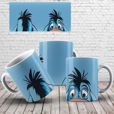 three coffee mugs with cartoon characters painted on them