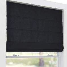 a black roman blind hanging on the side of a window