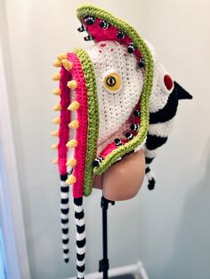 a crocheted hat on top of a mannequin's head