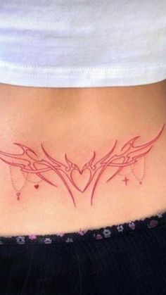 a woman's stomach with a tattoo design on the side and an arrow in the center