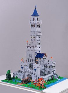 a lego model of a white castle with a blue roof