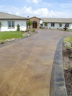 a driveway leading to a large house