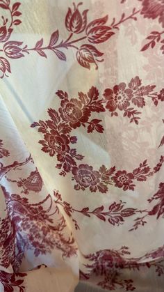 the fabric is red and white with flowers on it