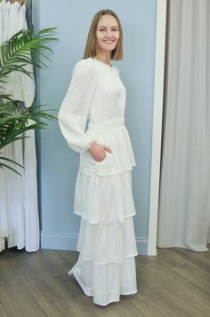 Come check out this new beautiful dress that we just got in. It is a soft stretchy fabric that flows and looks so elegant. This temple dress has pockets as well. Elegant V-neck Dress With Flowy Skirt, Modest V-neck Formal Dress, Elegant White Tiered Maxi Dress, Modest Long Dress For Dress Down Occasions, Long Sleeve Evening Maxi Dress, White Midi-length Elegant Ruffle Dress, Long Sleeve Maxi Dress For Evening, Bridesmaid Tiered Dress With Ruffle Hem, Fitted Maxi Dress With Ruffle Hem For Wedding