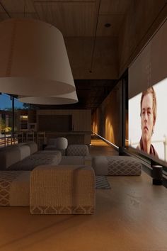 a living room with couches and a flat screen tv on the wall next to a large window