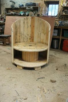 a wooden bench sitting in the middle of a room