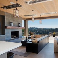 an outdoor living area with couches and fireplace